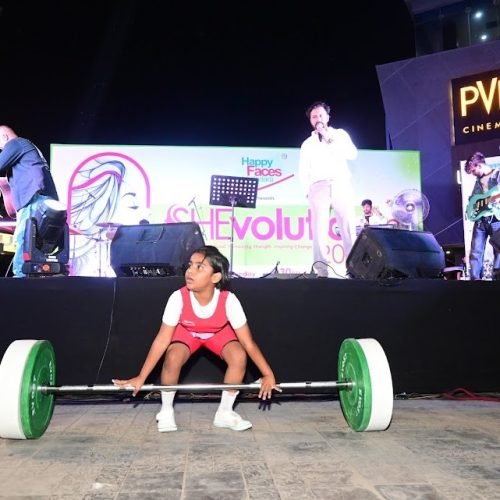 Young girl lifting weights at SheVolution event